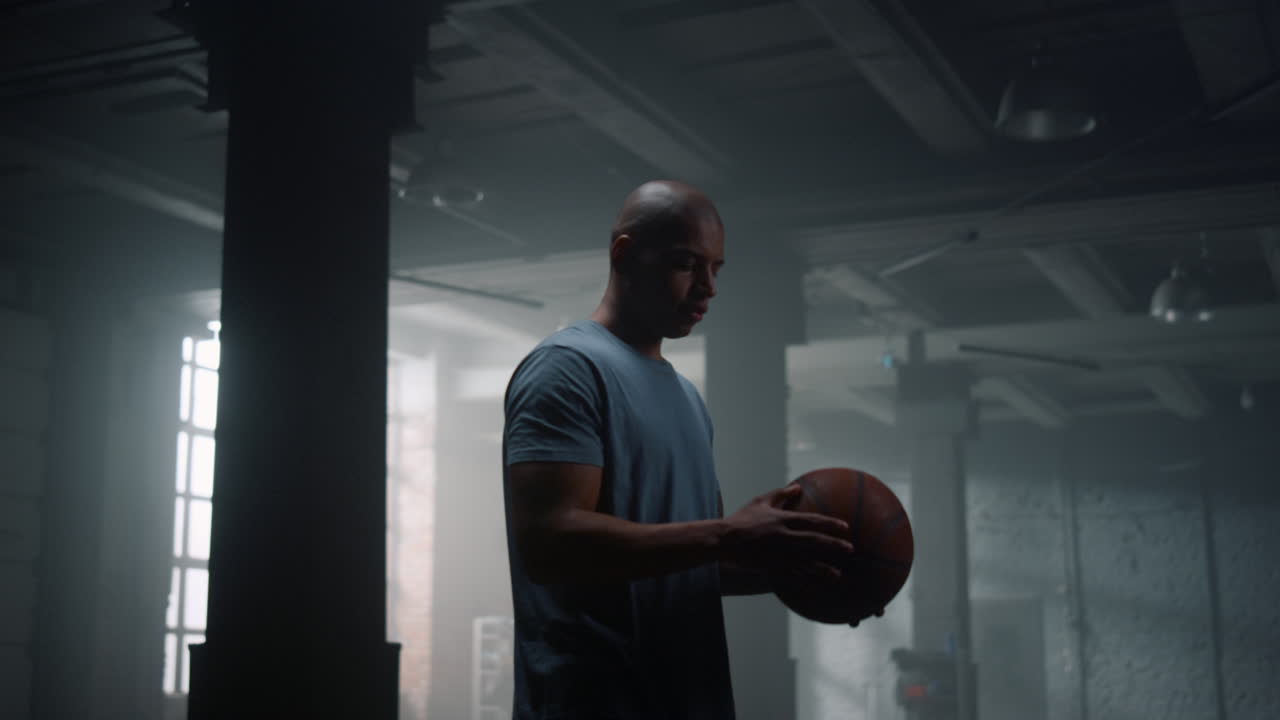 Guy spinning basketball ball on finger. Player balancing ball on finger