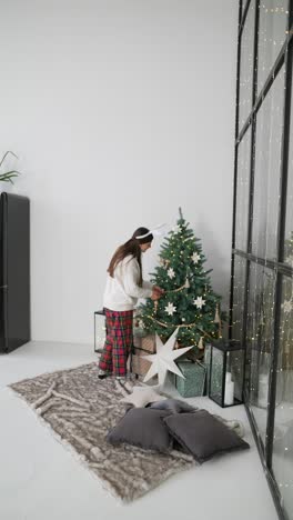 child decorating christmas tree