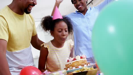 family celebrating a birthday in kitchen at home