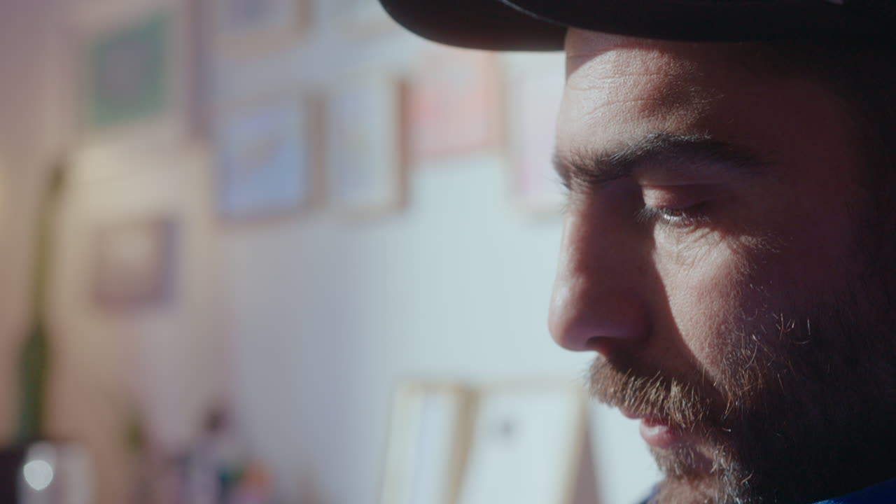 Male Artist Using Stylus and Digital Tablet for Drawing