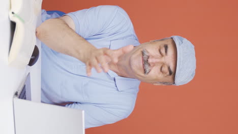 Vertical-video-of-Negative-expression-of-old-man-using-laptop.