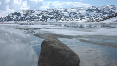 beautiful norway nature shot from water with mountains in the background