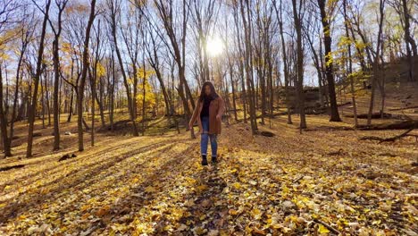 Niña-Jugando-Con-Hojas-En-El-Suelo-En-Un-Bosque-Durante-El-Otoño-Hermoso-Video-De-Viaje