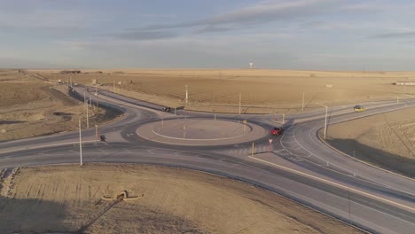 Cars-and-pickup-trucks-navigate-a-modern-roundabout-in-the-middle-of-the-countryside