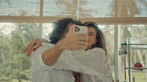 couple taking a selfie in a kitchen