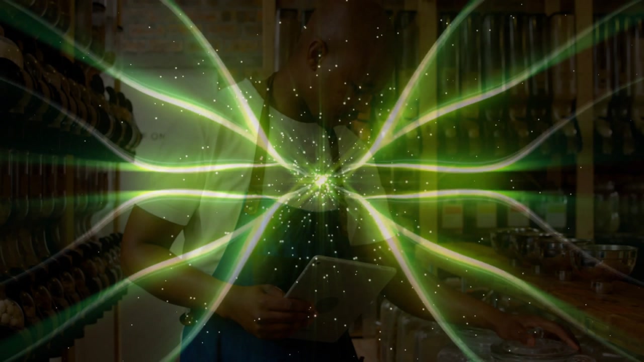 Green beams revealing man wearing apron scanning grocery shelves and dispensing grains, filling bag