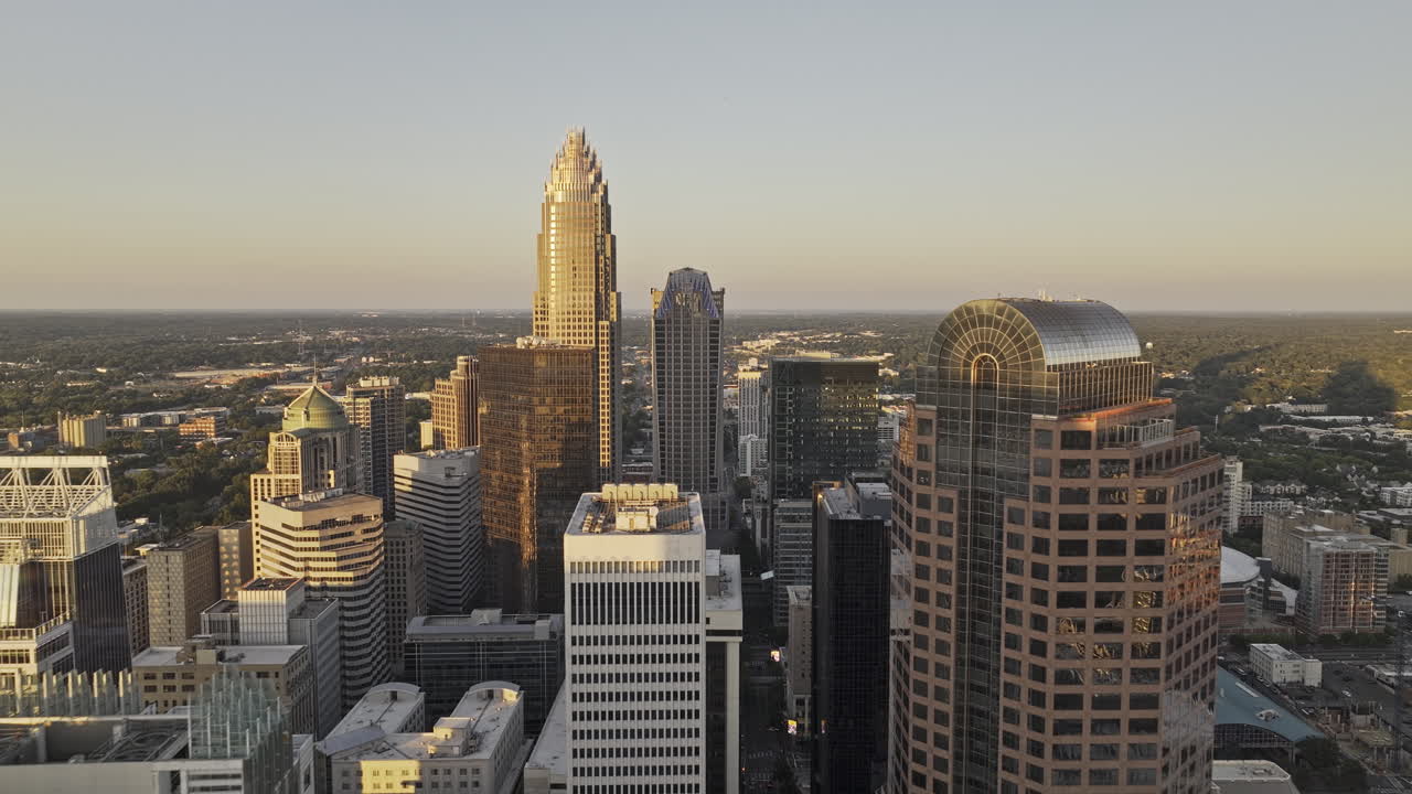 Charlotte North Carolina Aerial v149 low flyover the city center, weaving between towering skyscrapers capturing downtown cityscape at sunset golden hour - Shot with Mavic 3 Pro Cine - Oct 1st 2023