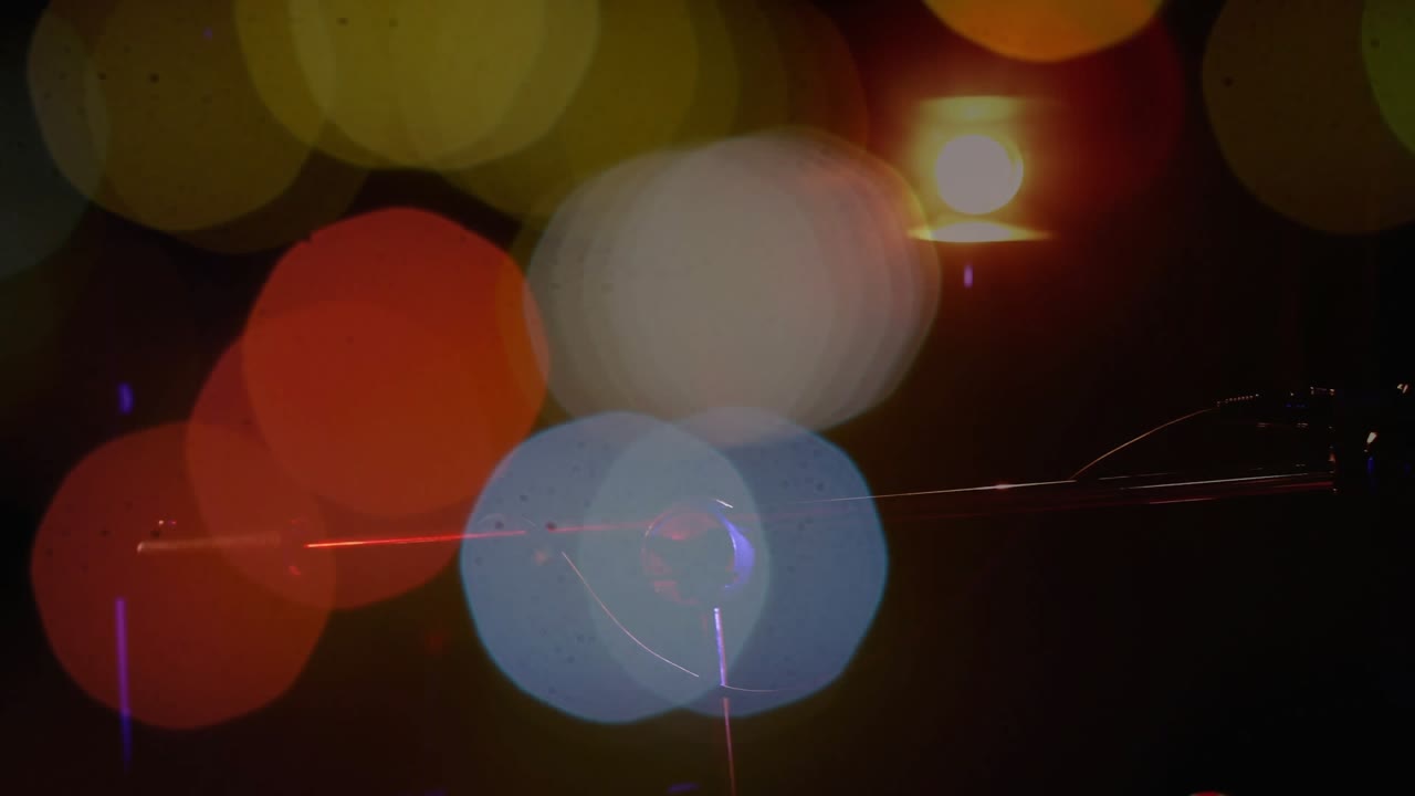 Female performer playing acoustic guitar, camera revealing hands while bokeh drifting during song