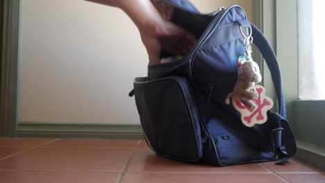 father packs child's backpack to be ready for school