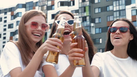 friends celebrating with beer in the city