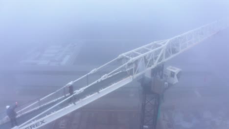 Aerial-drone-view-of-climate-change-XR-protesters-on-top-of-crane,-circle-pan