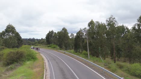 main avenue and cyclists competing, navidad commune, ohiggins region, chile