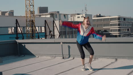 funny woman dancing on rooftop celebrating enjoying silly dance having fun crazy dancer girl in city