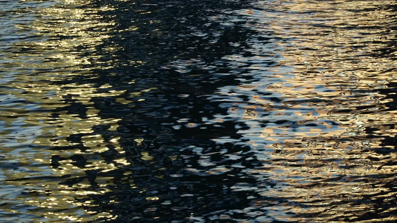reflejos en la superficie del agua de mar, bucle de agua negro y dorado brillante, fondo de la superficie del agua, superficie de agua multicolor, bonito fondo de bucle 4k
