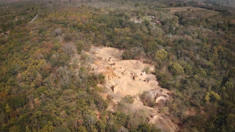 aerial view of ghost pillars in pae muang pee forest park surrounded by tropical vegetation