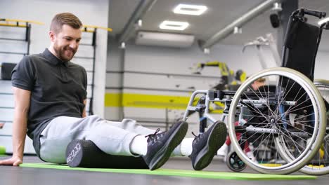 man with disability trains punches holding dumbbells in gym man with disability trains punches holding small dumbbells near boxing ring athlete with prosthetic leg expresses powerful spirit exercising in gym slow motion