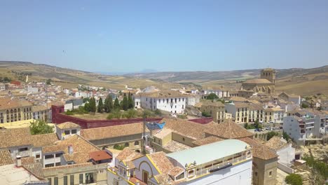 aerial tilt-up reveal view of the town o alhama de granada with its famous church on the right