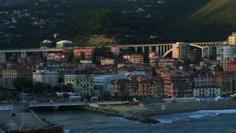 stunning aerial view of bustling coastal comune of varazze, italy with colorful buildings and mountainous background