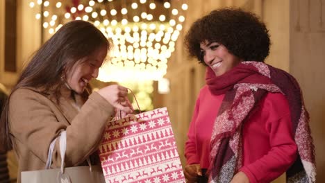 two women friends celebrating outdoors after shopping