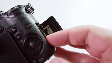 Close-up-of-a-technician-inserting-and-pushing-the-SD-card-into-the-slot-then-closing-it