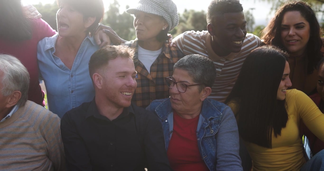 Happy Multi-Ethnic Group of Friends Talking and Smiling Outdoors