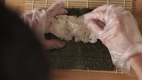 Topshot-of-chef-preparing-sushi-rolls-in-the-kitchen