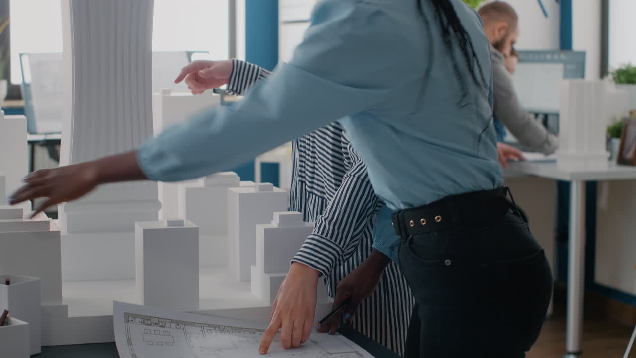 Architectural planning with building model and blueprint