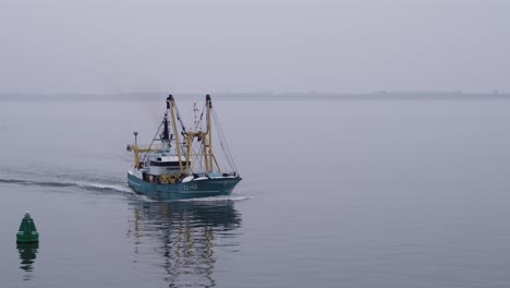 fishing boat in a misty sea