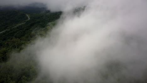 Aerial-view-flying-above-lush-green-tropical-rain-forest-mountain-with-rain-cloud-cover-during-the-rainy-season-on-the-Doi-Phuka-Mountain-reserved-national-park-the-northern-Thailand