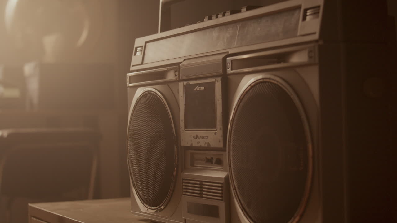 Loading Cassette Tape by Hand into Classic Retro Boombox under Warm Light
