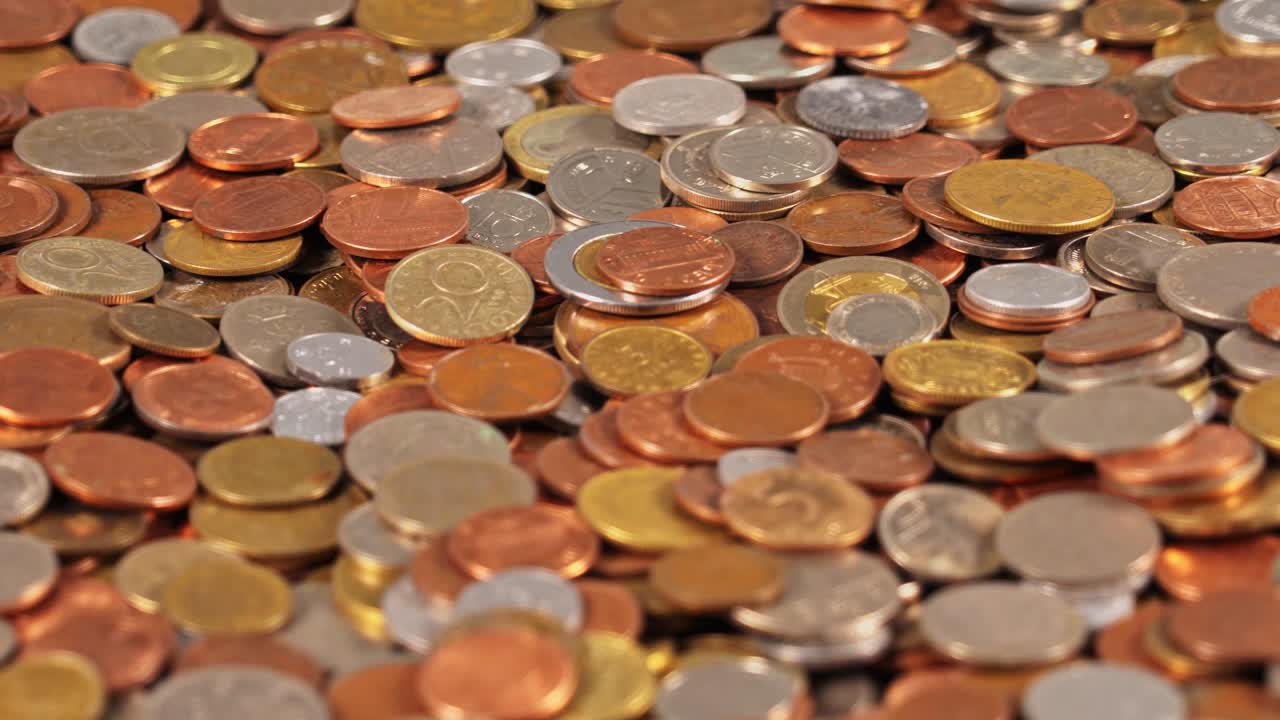 Coins arranged on a flat surface in various sizes and colors