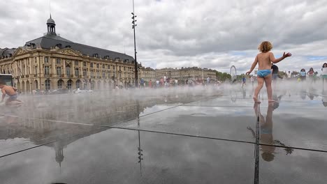 kids enjoying water mist in bordeaux square