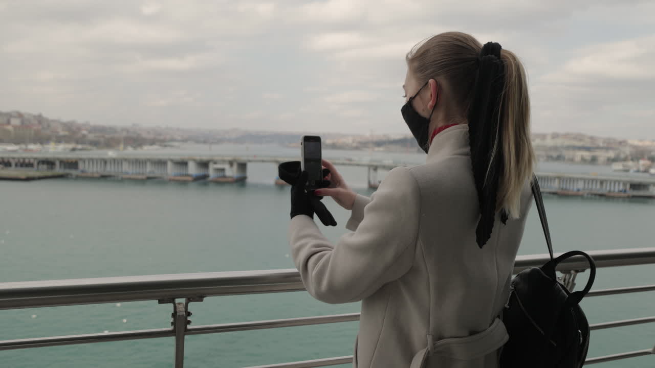Woman taking picture of city view