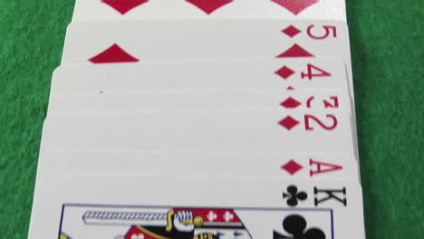 the camera moves across a deck of cards laid out on a casino table