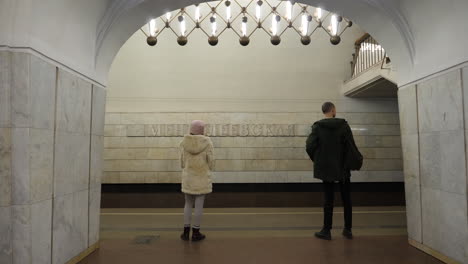 commuters waiting for moscow metro train at mayakovskaya station platform, russia