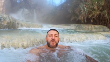 man bathing in the baths of saturnia