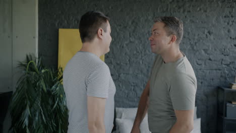 two men talking in a room