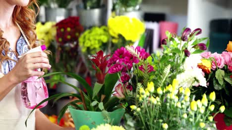 Female-florist-watering-flowers