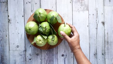 Top-view-of-hand-pick-guava-on-table-,