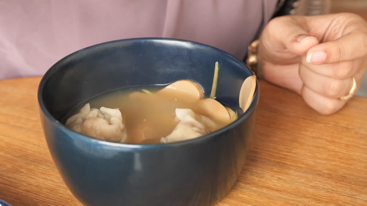Woman Eating Delicious Wonton Soup
