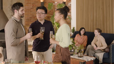 a group of three friends talking at a dinner party