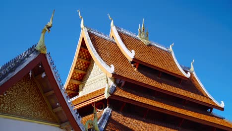 parallax of traditional architecture of buddhist temple roof top on clear blue skys