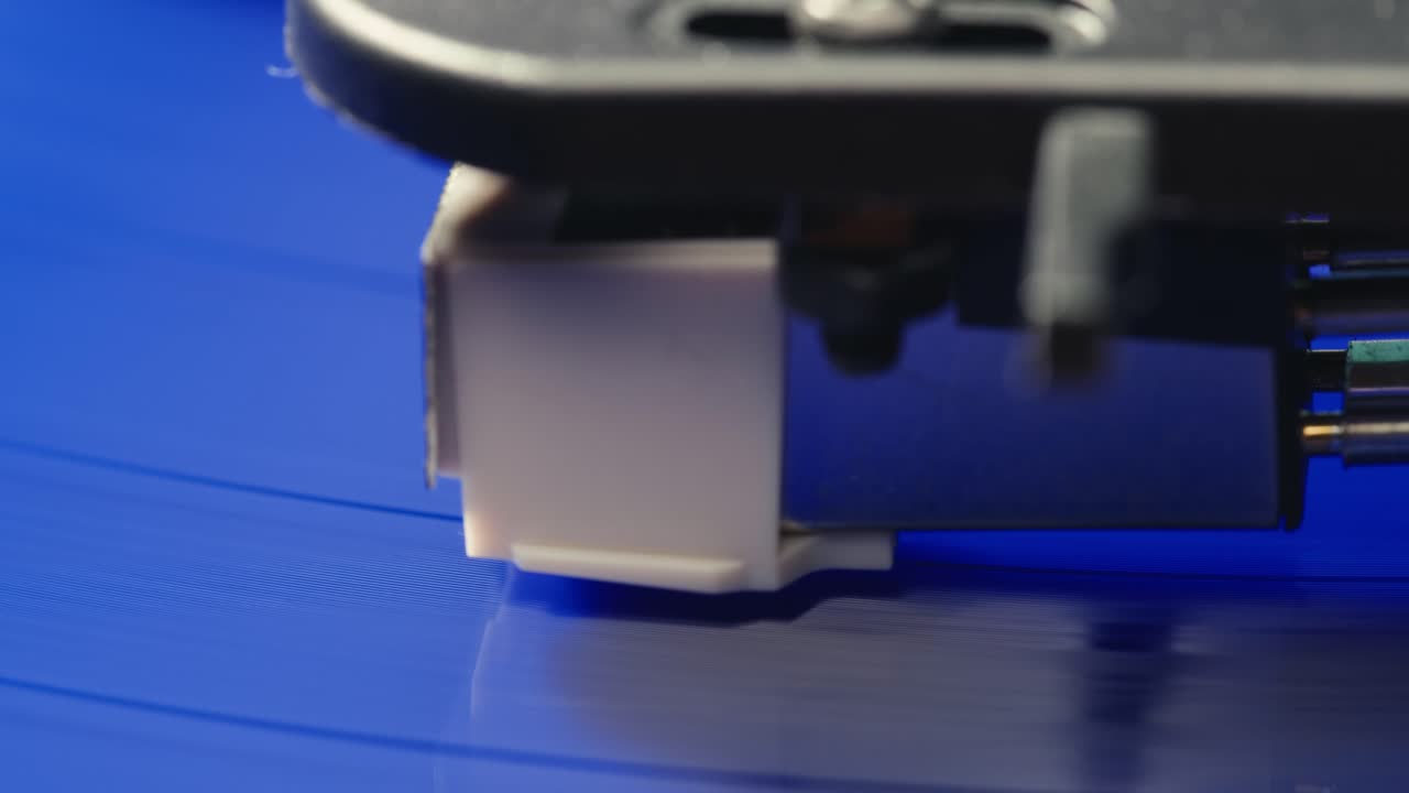 Close-up of Turntable Stylus Playing Blue Vinyl Record