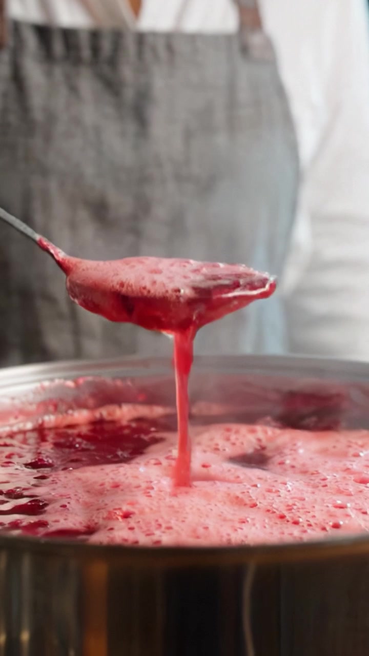 Cooking Process: Bubbles Forming in a Pot of Simmering Red Sauce or Jam, Showcasing the Transformation of Ingredients Over Time