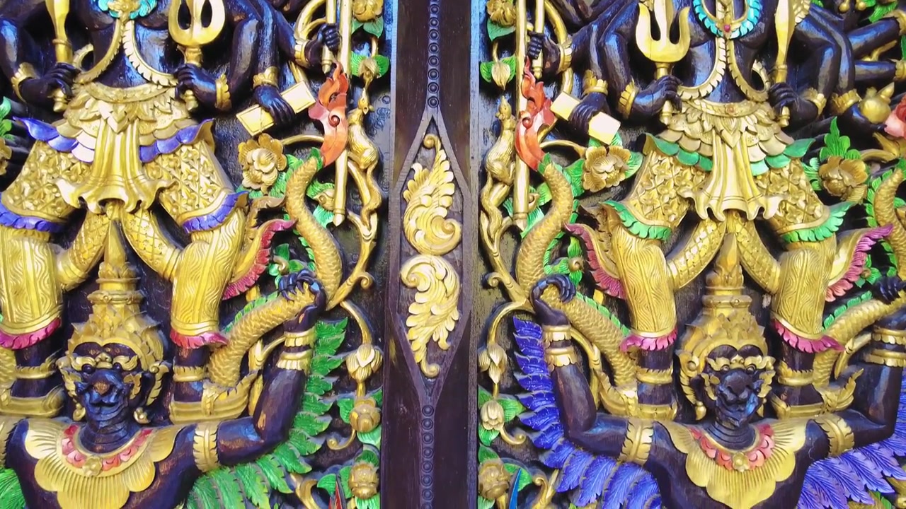 Detailed close up shot of a golden bhudist temple door in Thailand