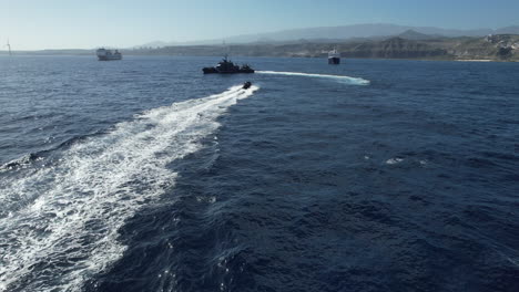 fantastic aerial shot of a speeding boat of the national police approaching a police patrol boat