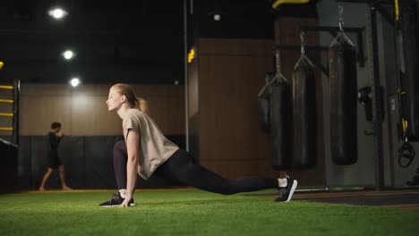 active fitness woman making stretching in sport club. fit girl exercising at gym