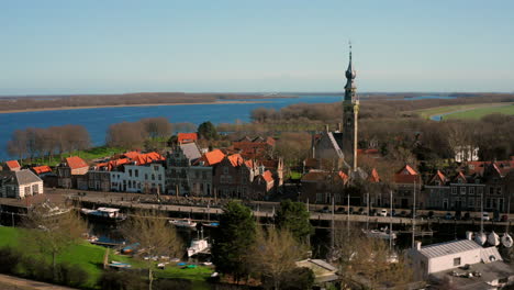 aerial: the historical town of veere with an old harbour and churches, on a spring day