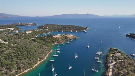 low flight over small bay on coast of greece with moored sailboats