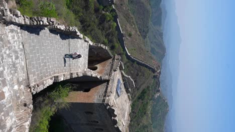 solo traveler visiting jinshanling section of the chinese great wall. vertical